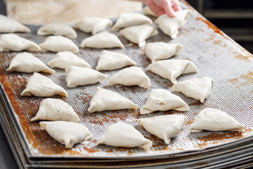 billet bun of dough with filling inside. Prepared for baking in baking production.