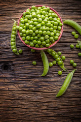 Peas. Fresh bio homemade peas and pods on old oak board. Healthy fresh green vegetable - peas and...
