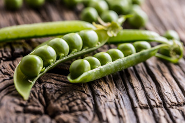 Peas. Fresh bio homemade peas and pods on old oak board. Healthy fresh green vegetable - peas and pods.