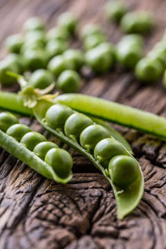 Peas. Fresh bio homemade peas and pods on old oak board. Healthy fresh green vegetable - peas and pods.