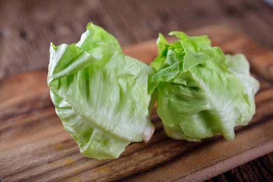 fresh butterhead lettuce on board and wooden background
