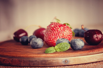Fresh berries on a wooden cutting board 