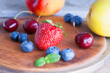 Fresh fruits on a wooden cutting board 