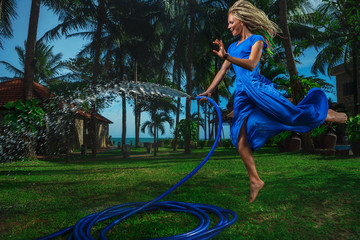 Woman watering with garden hose