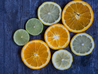 Fototapeta na wymiar Citrus fruits slices, orang, lemon, lime, on colorful background top view