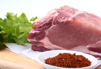 Raw pork chops with herbs and spices on cutting board. Ready for cooking.