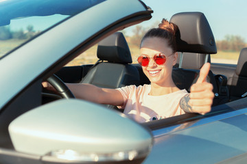 Fototapeta na wymiar Relaxed happy woman traveling in a car
