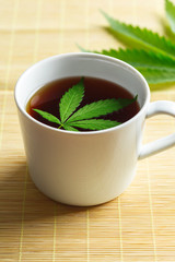 Cannabis herbal tea and marijuana leaves