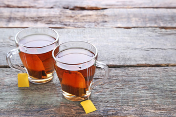 Cup of tea with teabag on wooden table