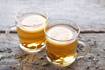 Cup of tea with lemon on wooden table