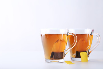 Cup of tea with teabag on a white background