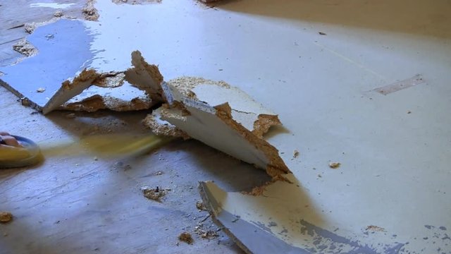 A particle board sub floor is torn to pieces with crowbar by homeowner during renovation project.