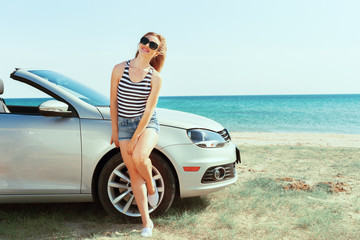 Relaxing woman on the beach in the car