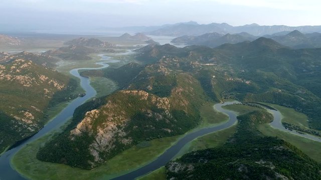 Flying over Rijeka Crnojevica River. Northern area of Skadar Lake National Park in Montenegro