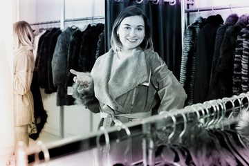 Female customer examining new sheepskin coat