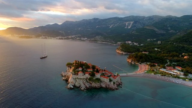 Flying over Sveti Stefan island in adriatic sea, Montenegro. UHD, 4K