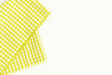 Yellow fabric, kitchen towel with checkered pattern, isolated on white background isolated