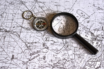 old military topographical map, magnifier and compass