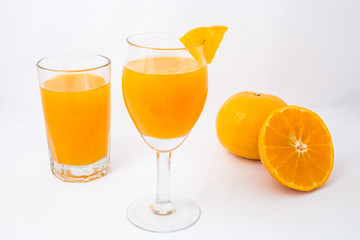 Orange juice and slices isolated on white