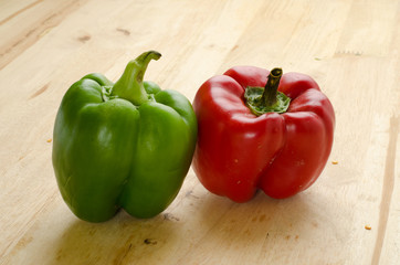 green and red bell pepper on wood table