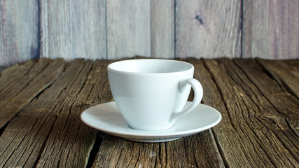 Fototapeta na wymiar An empty coffee cup on a wooden table