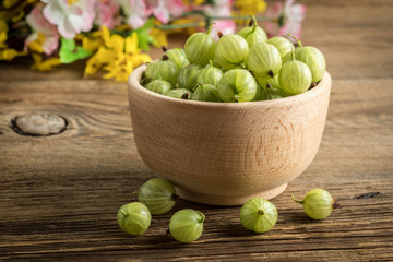 Fresh gooseberry in a wooden bowl.