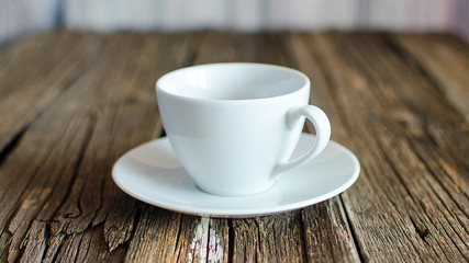 An empty coffee cup on a wooden table