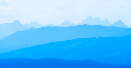 Fototapeta na wymiar Spectacular view of mountain ranges silhouettes in blue twilight hour