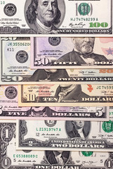 Abstract dollar bills of different denominations background.