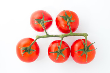 Bunch of fresh tomatoes with water drops. Isolated on white background. Top view.
