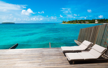 sunbeds on a deck on a tropical island