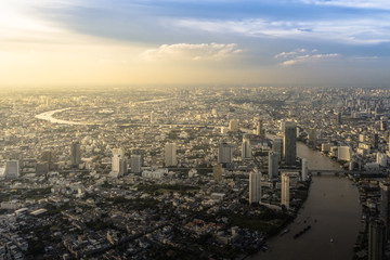 Fototapeta na wymiar Beautiful Aerial view of the city and the river at sunset - Bangkok, Thailand