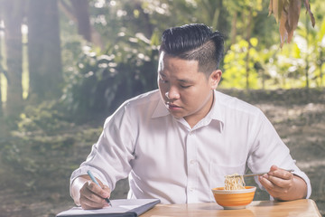 Portrait Asian Businessmen Eating Noodle  Working in Nature concept.