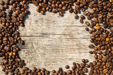 Coffee beans frame on grunge wooden background