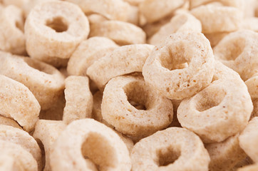 Beige rings corn flakes closeup background. Cereals texture.