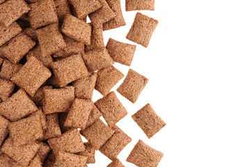 Decorative border of chocolate pads corn flakes isolated with copy space background. Cereals texture.