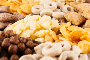 Corn flakes set -  rings, stars, balls, chocolate as decorative cereals background. Top view.