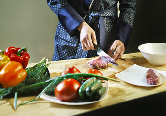 Man cuts the meat with a knife