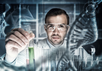 Young scientist mixing reagents in glass flask in clinical laboratory