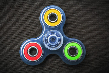 Blue transparent Fidget Spinner with colorful rings, stress relieving toy