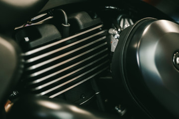 Close up view of a shiny black motorcycle engine. Motor bike detail