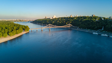 Aerial top view of pedestrian Park bridge and Dnieper river from above, city of Kiev, Ukraine
