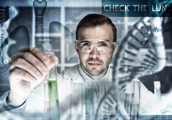 Young scientist mixing reagents in glass flask in clinical laboratory