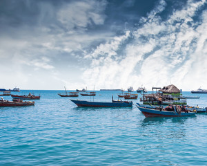 seascape with many anchored fishing boats near an african island