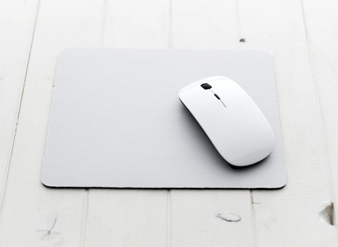 White Wireless Mouse On A Mouse Pad