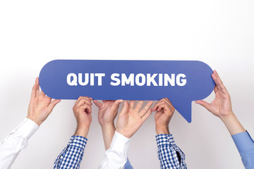 Group of people holding the QUIT SMOKING written speech bubble