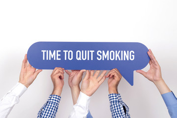 Group of people holding the TIME TO QUIT SMOKING written speech bubble