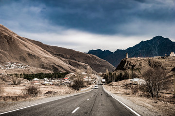 Landscape with views of military road in Georgia via traditional village
