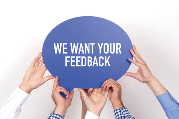 Group of people holding the WE WANT YOUR FEEDBACK written speech bubble