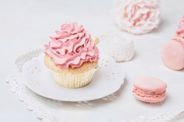 Pink cupcakes with roses and macaroons. Festive and bright. Wedding Celebration concept.